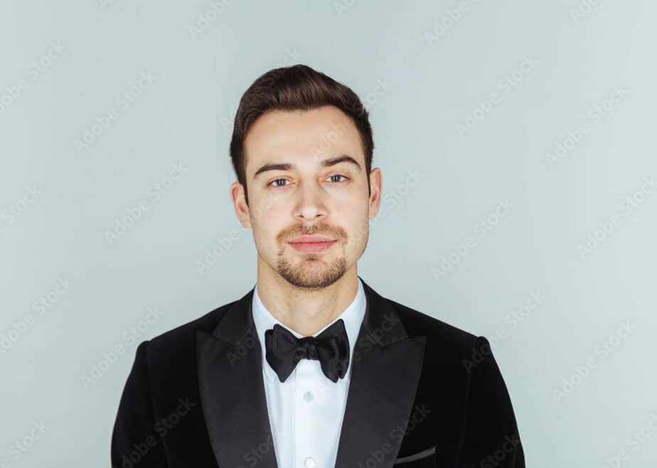Young handsome man in a traditional wedding tux, looking at the camera